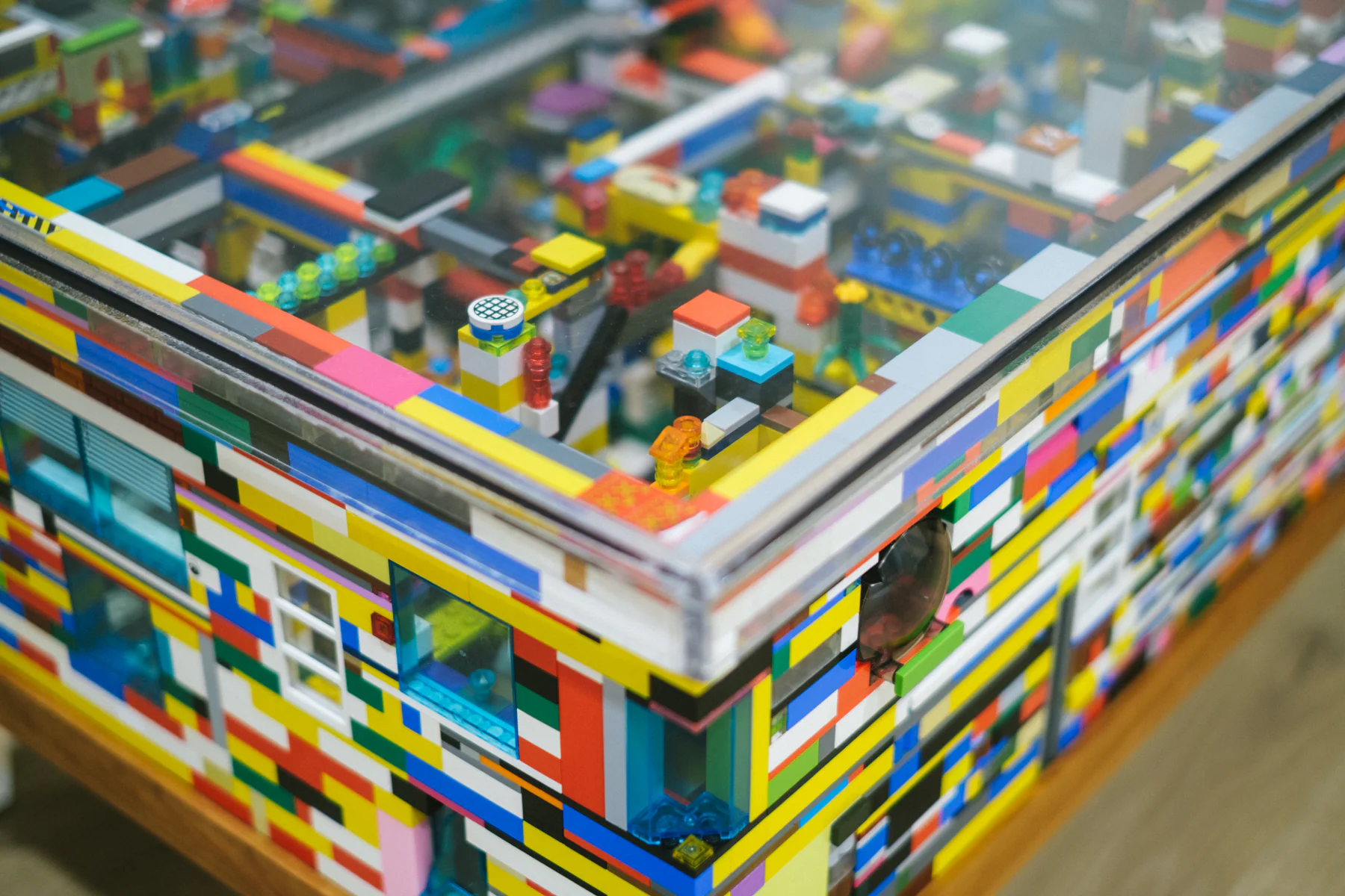 Detail of the waiting-room coffee table built from colourful building bricks under glass